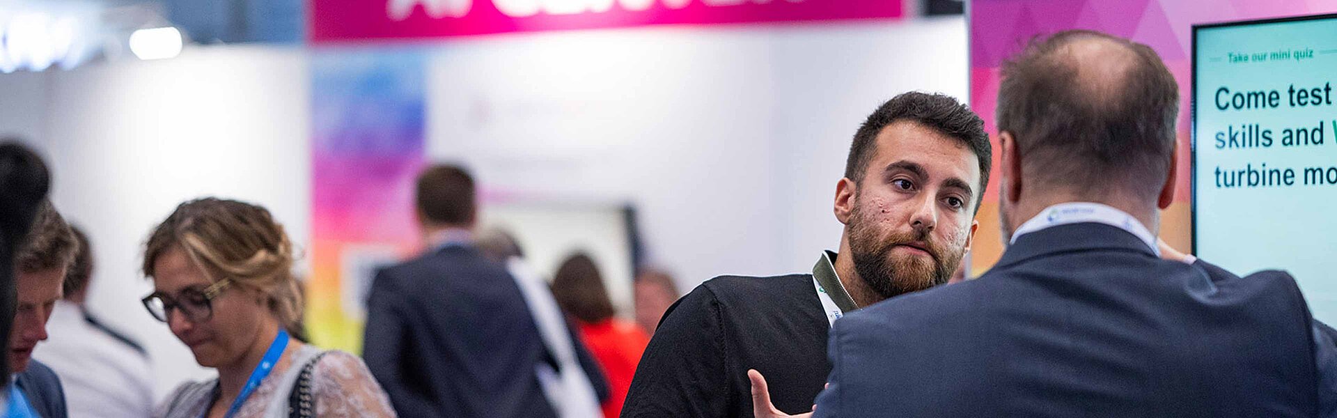 People chatting at the AI ​​Center at WindEnergy Hamburg 2024.