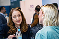 Three people have a lively chat over a drink at WindEnergy Hamburg.