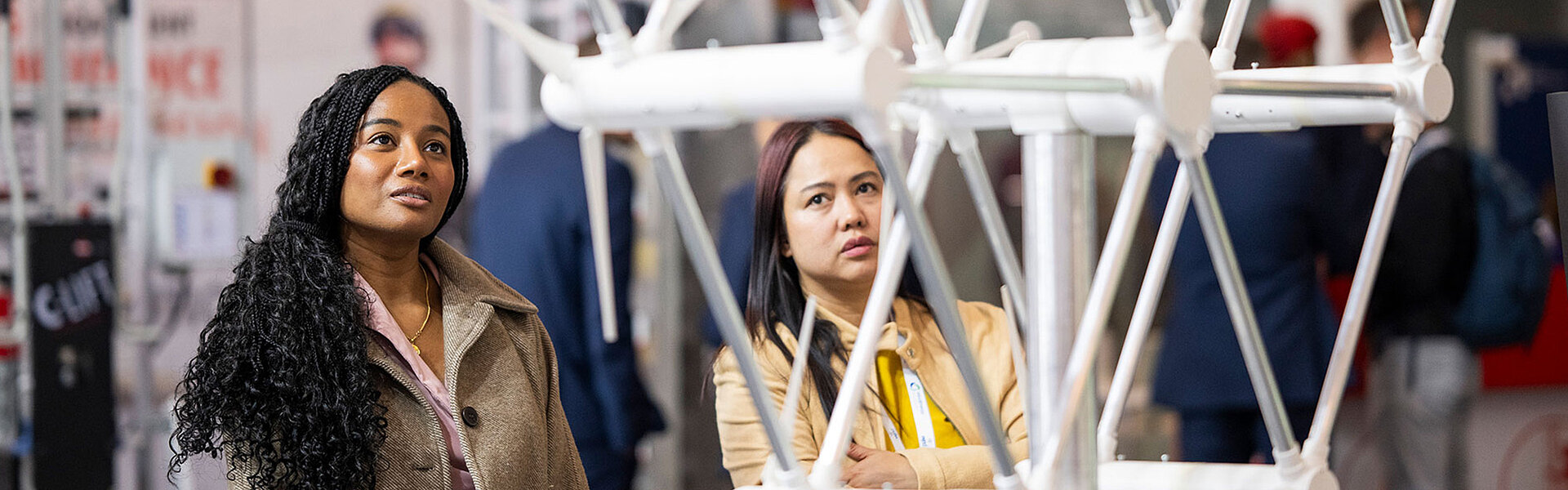 Two women look at an exhibit at WindEnergy Hamburg.